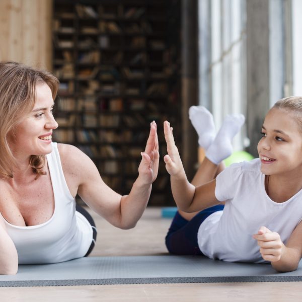 mother-daughter-high-fiving-yoga-mats