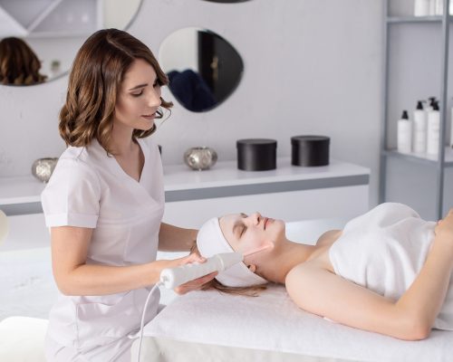 Teen girl performs salon cosmetology procedure on her face